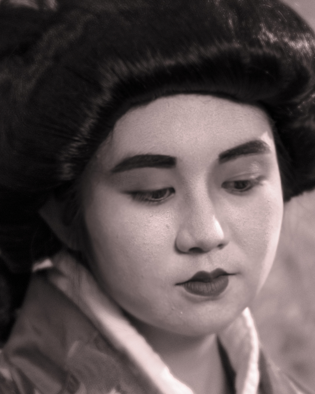 A quiet portrait in soft monochrome tones, capturing a moment of reflection through delicate detail and timeless expression.