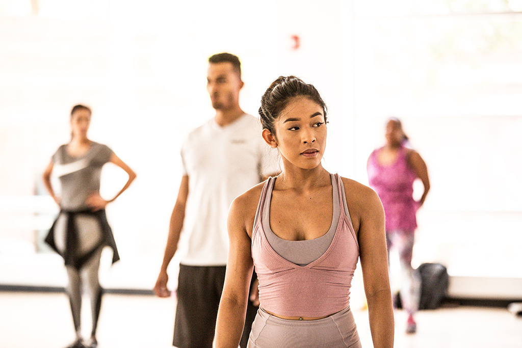 Centered and ready, this moment captures focus, strength, and the collective energy of a group fitness class preparing to move.