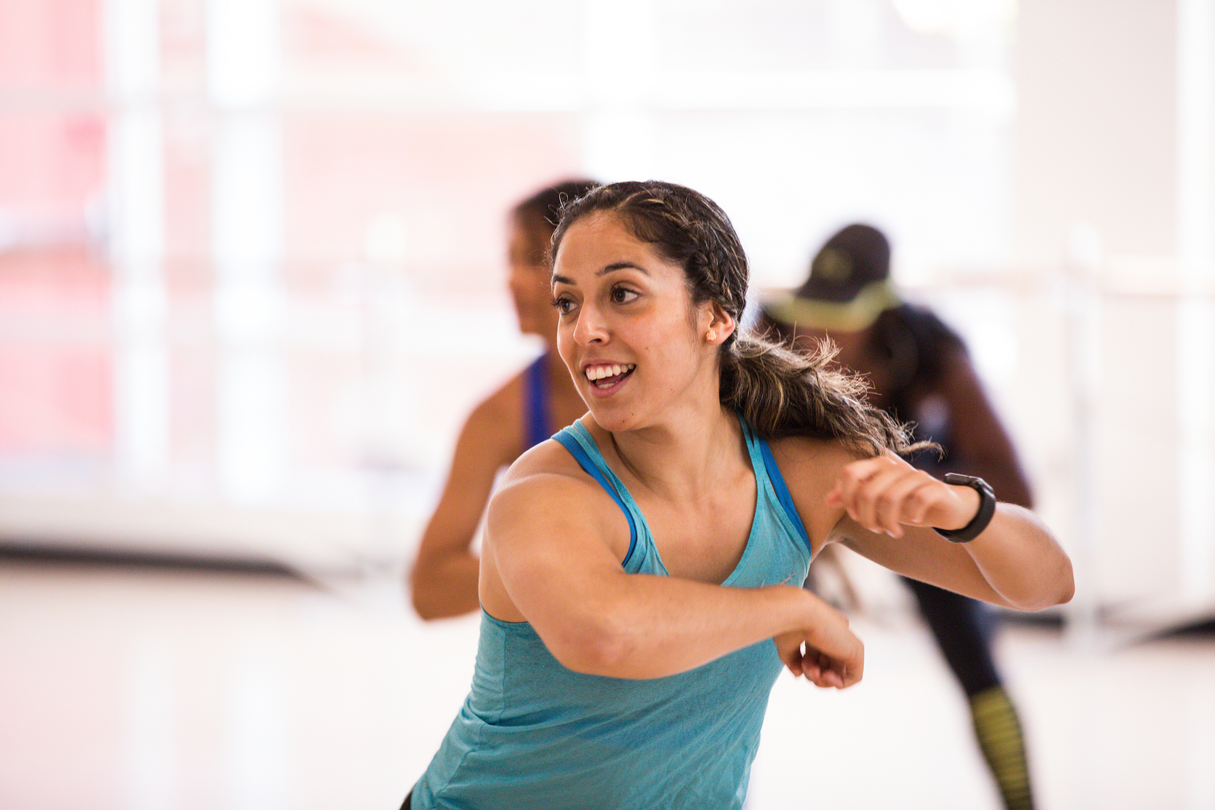 Full of energy and enthusiasm, this dynamic moment captures the rhythm, movement, and community spirit of a high intensity group fitness class.