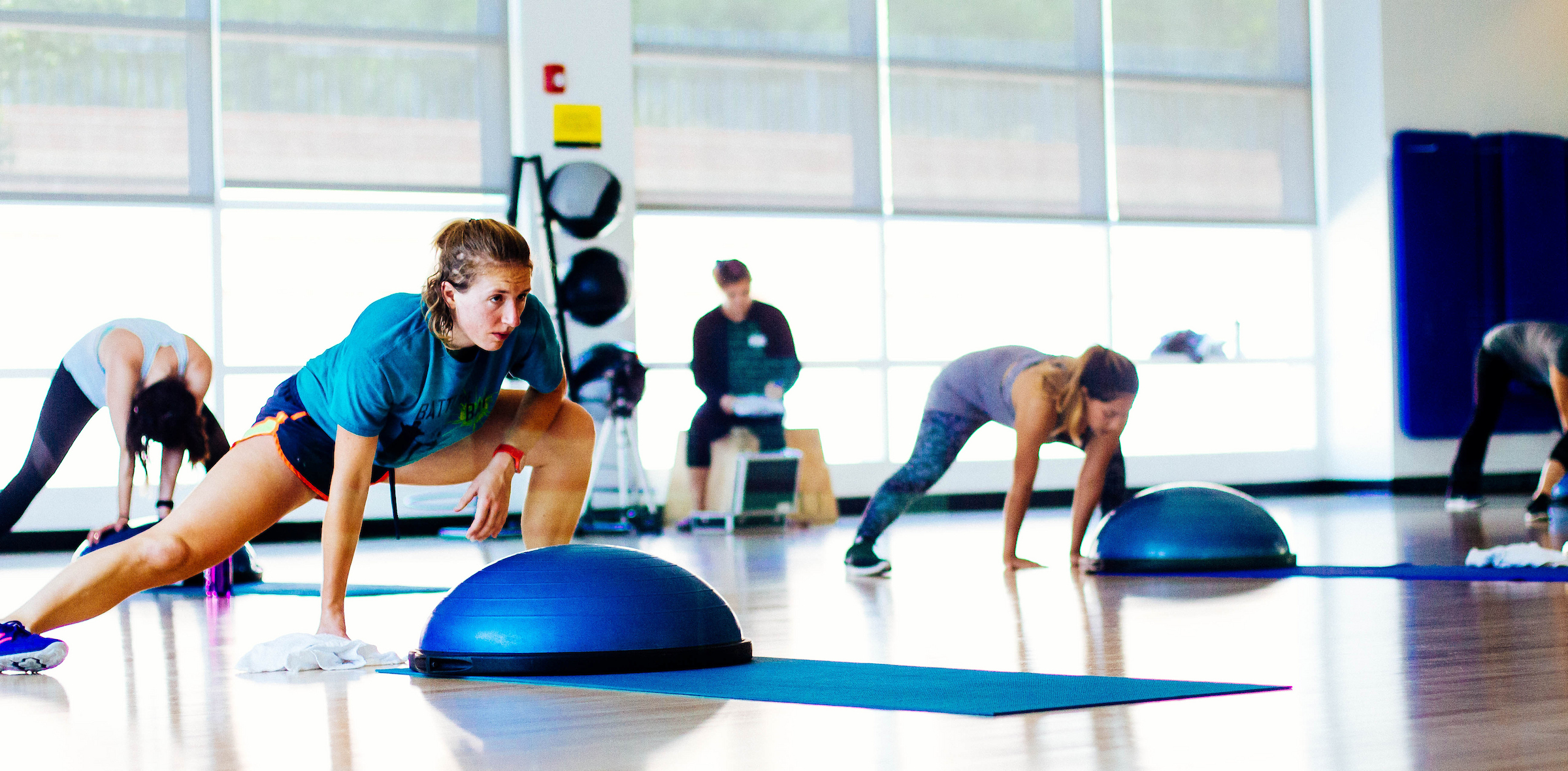 A focused group fitness session in motion, where balance, strength, and determination come together on the studio floor.
